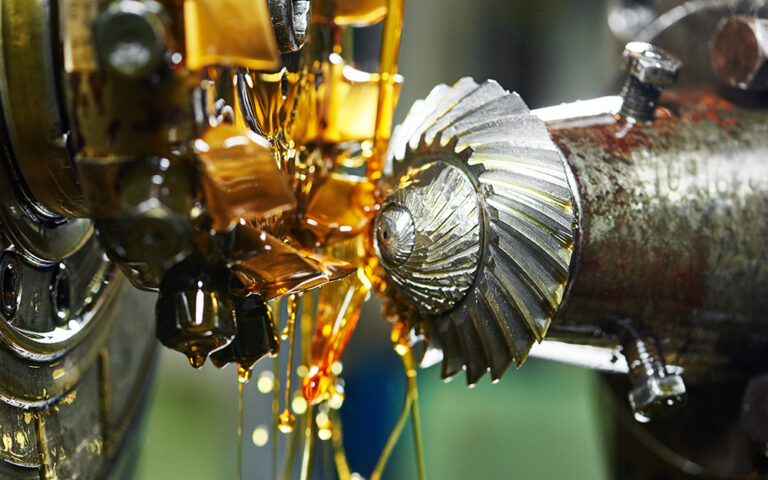 metalworking industry: conic tooth gear wheel machining by hob cutter mill tool. Selective focus on teeth.